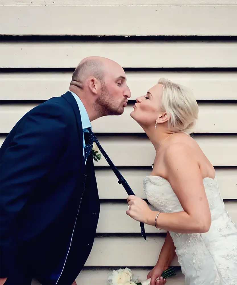 Quirky newlyweds in front of white door in Worcester