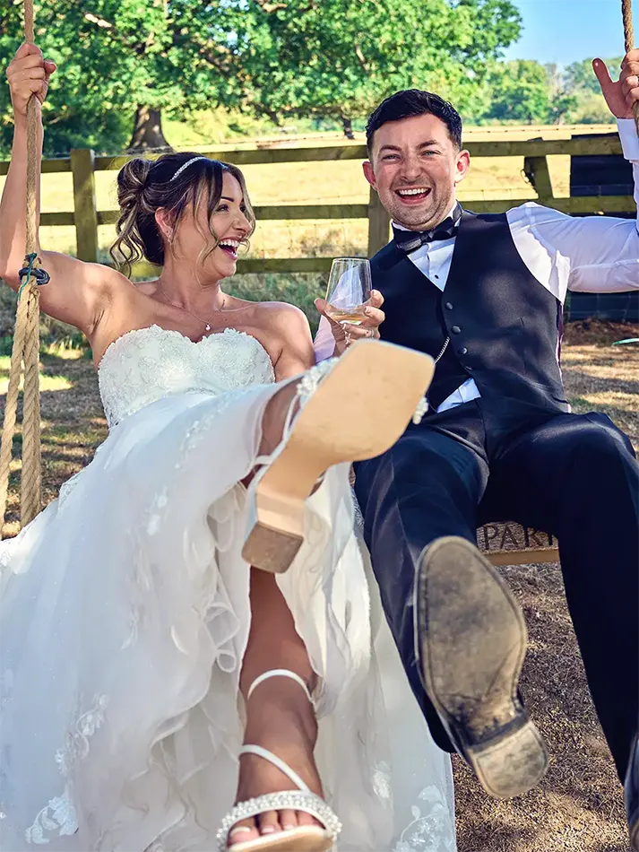 Just married couple on a swing at a Stourbridge manor wedding
